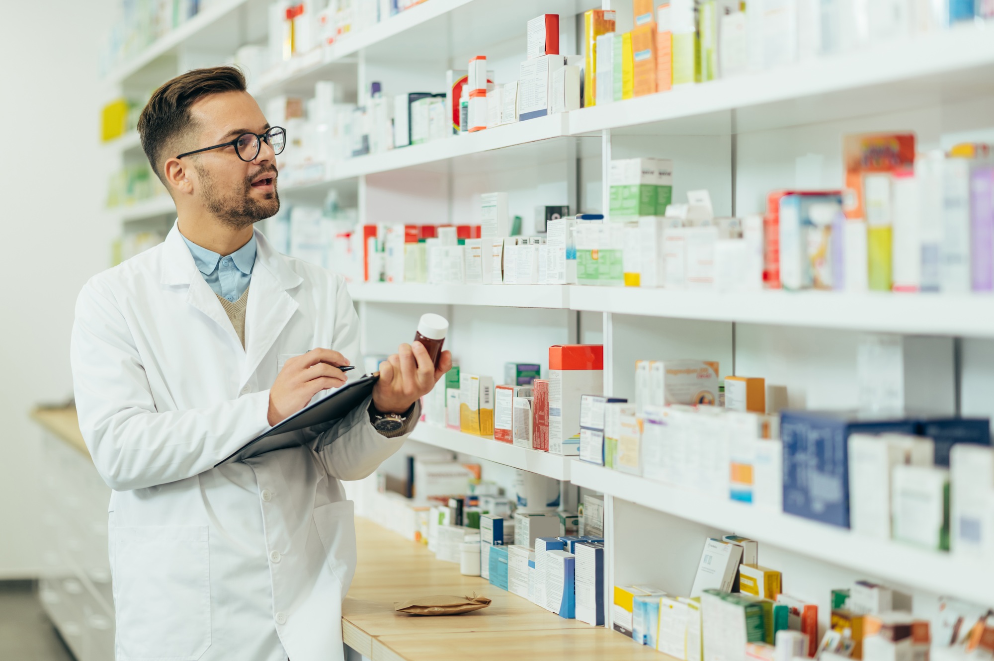 Portrait of a handsome pharmacist working in a pharmacy